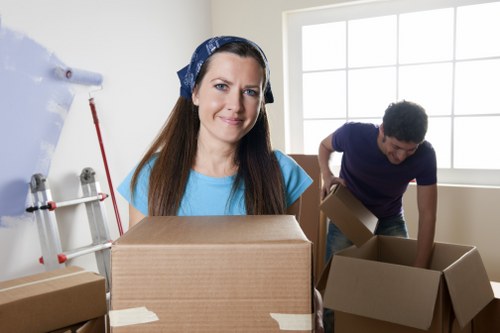 Local removalists handling boxes and furniture in a residential street